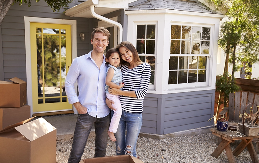 Family in front of new home